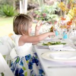 little girl eating at table